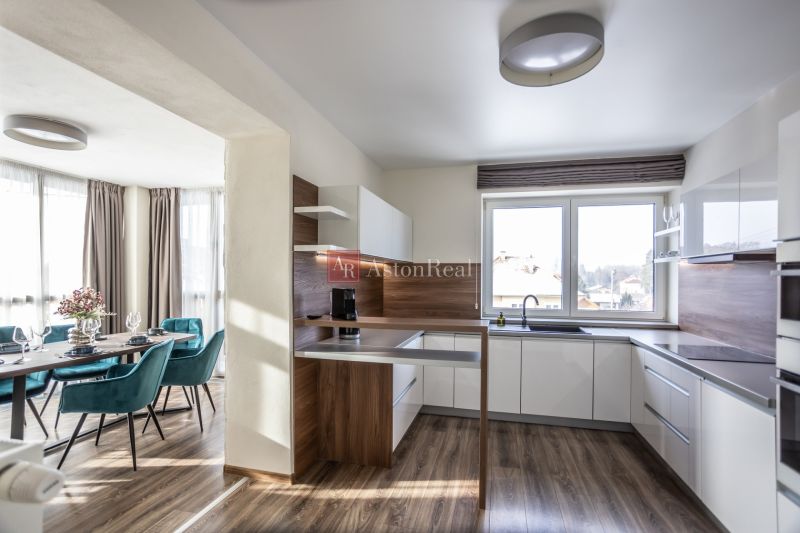Kitchen with dining area, wooden decor flooring, 2-room apartment.