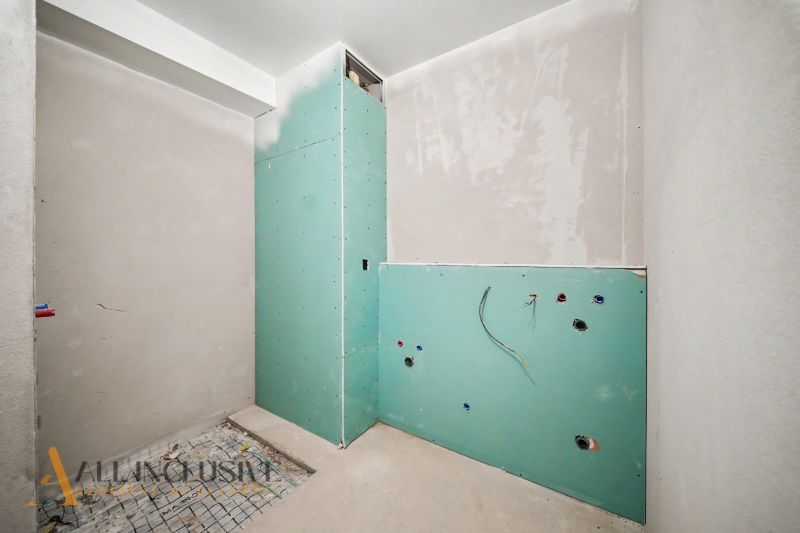The construction state of the bathroom in a 2-room apartment with installation of plumbing prepared for equipment.