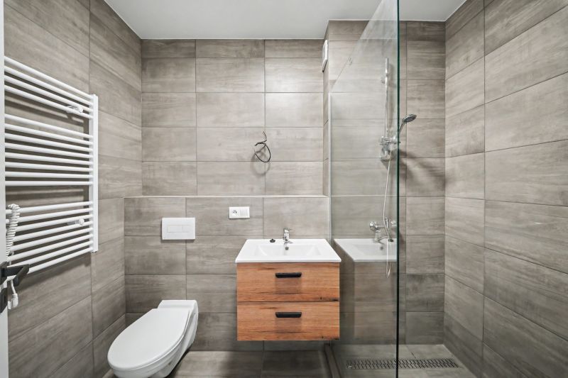 Bathroom in a 2-room apartment with tiles and a shower corner.