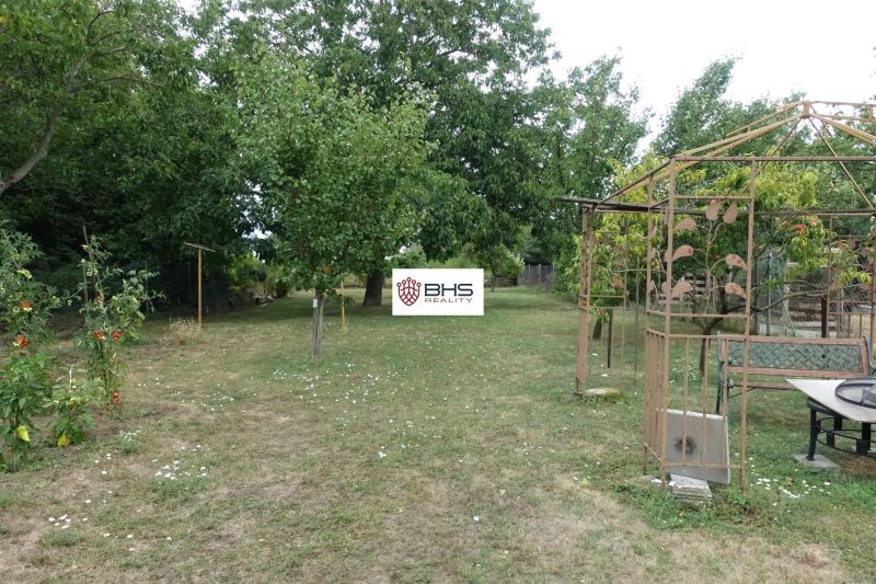 A garden at a family house on the Third Row in Mojmírovce with a gazebo and fruit trees.