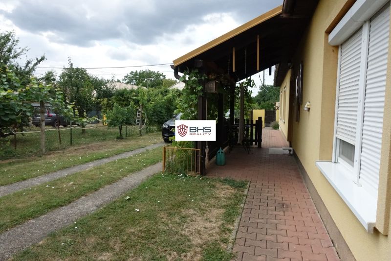 A family house on the Third Row in Mojmírovce with a garden terrace and a grass-covered plot.