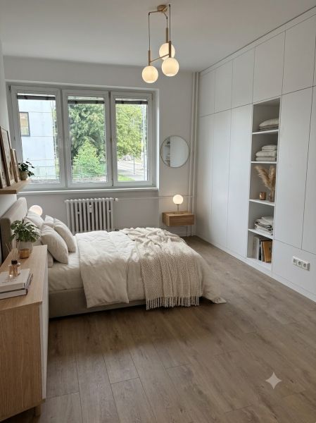 Bright bedroom with a built-in wardrobe and bed in a 4-room apartment, floor with wood decor.