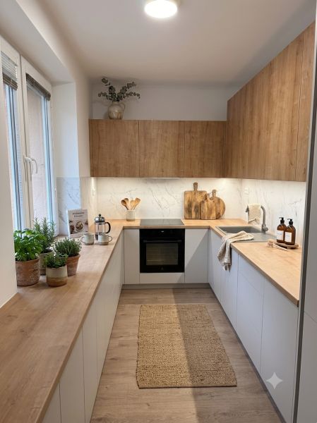 Kitchen in a 4-room apartment with storage space and flooring with a wood decor.