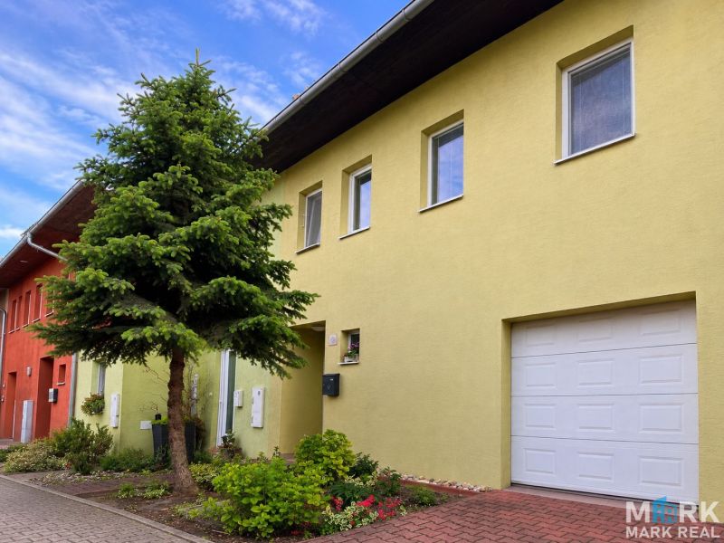 Family house on Hrabová Street in Hamuliakovo with a yellow facade and a garden.