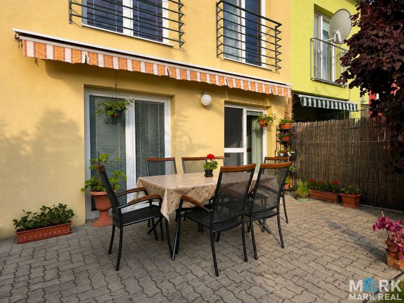The terrace of a family house on Hrabová Street in Hamuliakovo with outdoor seating and an awning.