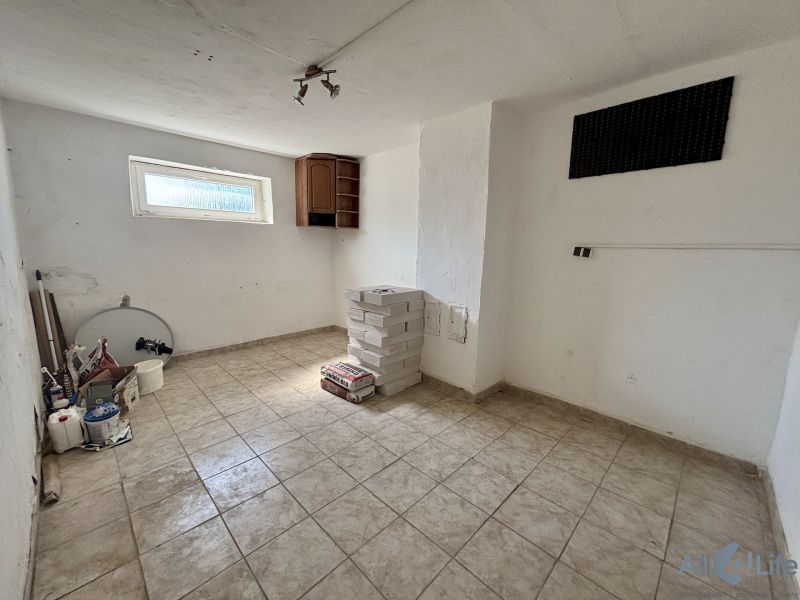 Room ready for renovation with tiles and tools, 3-room apartment.