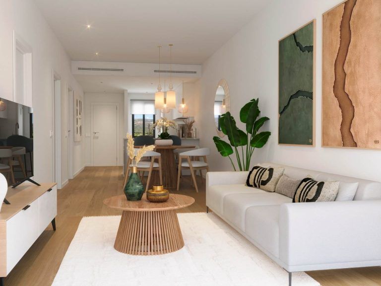 A bright living room in a three-room apartment with a wooden decor floor and stylish furniture.