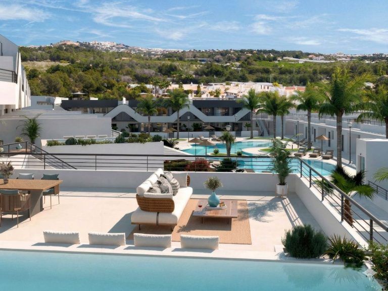 A terrace with a view of the pool in a 3-bedroom apartment on the Costa Blanca.