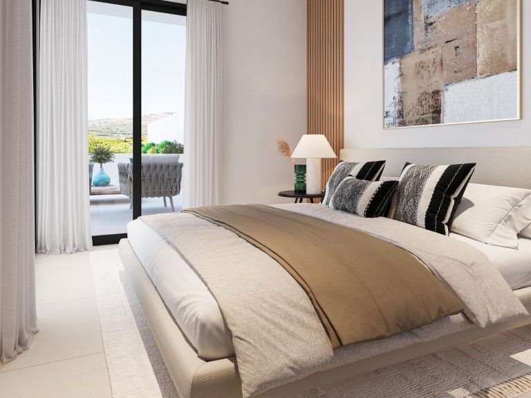 Bedroom of a 3-room apartment with a bed, decorative pillows, and a terrace.