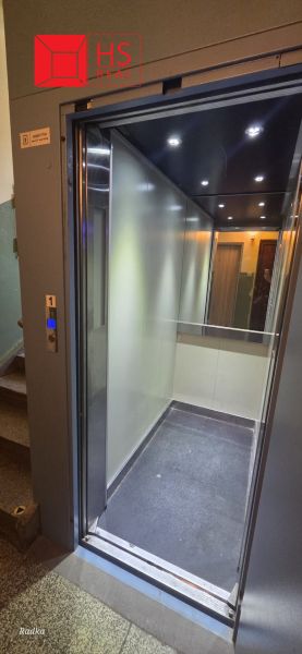 Elevator open on the ground floor in an apartment building.