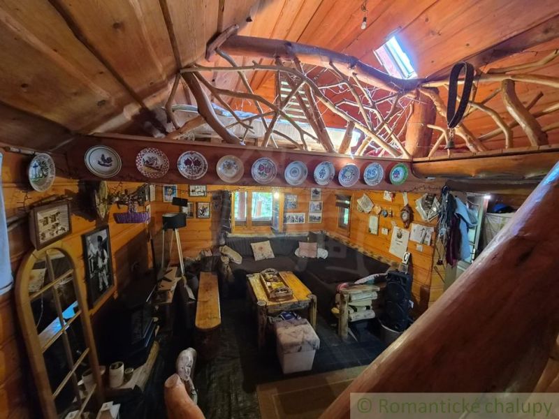 A rustic interior of a family house with wood, decorative plates, and cozy seating.