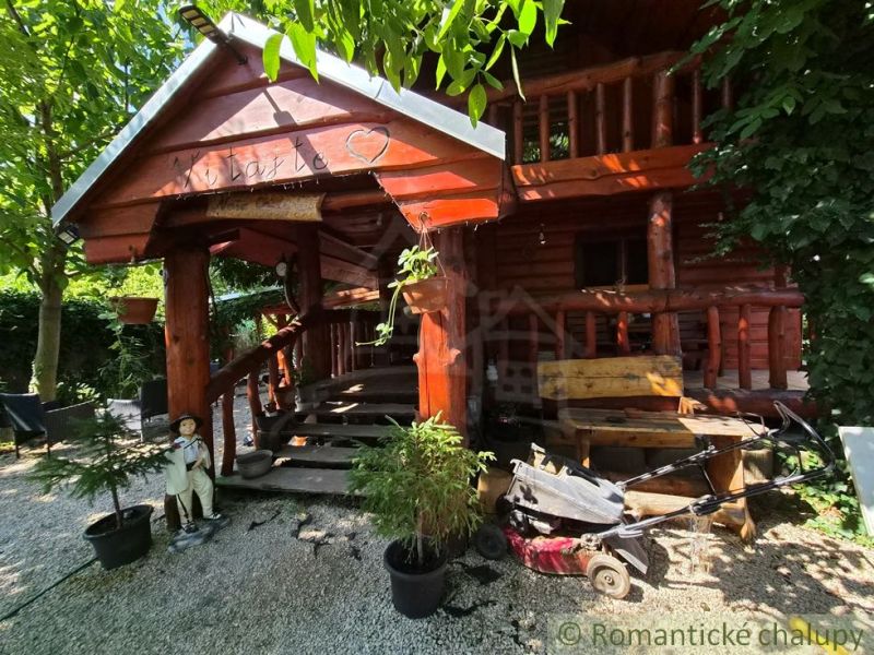 A rustic family house in Lehota with wooden decor surrounded by greenery.