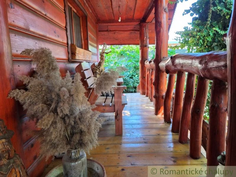 Wooden porch of a family house in Lehota with rustic details and natural decorations.