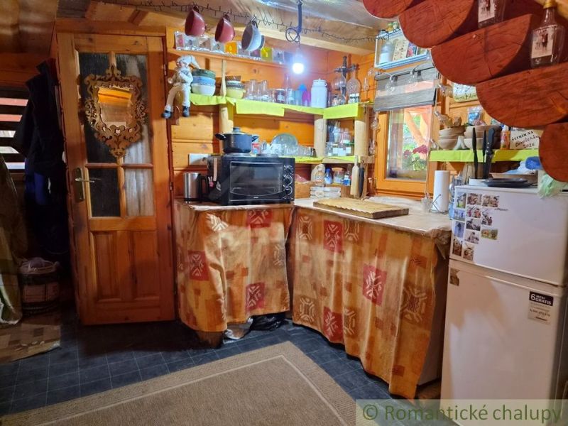 Rustic kitchen in a family house with wooden decor and traditional decorations.