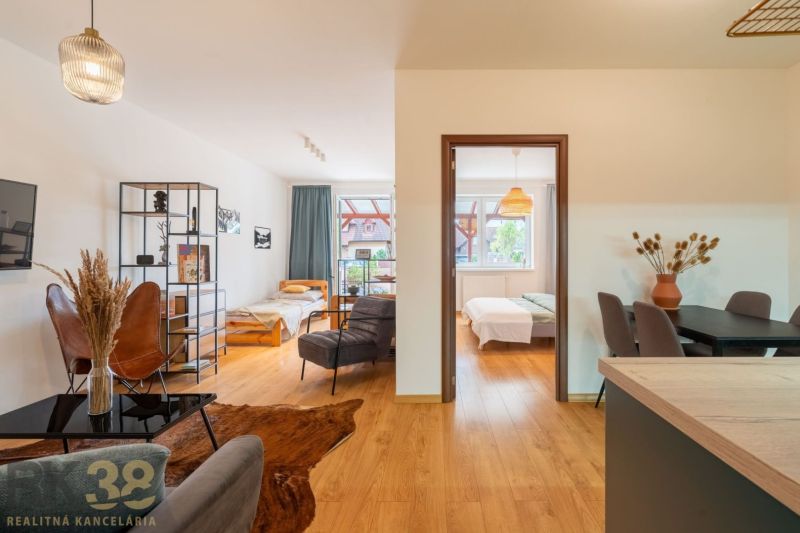 Interior of a 2-room apartment with a wooden decor floor and comfortable seating.