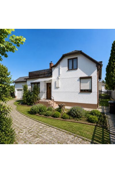 A family house on 29th August Street in Trebišov, with a landscaped garden and a paved road.