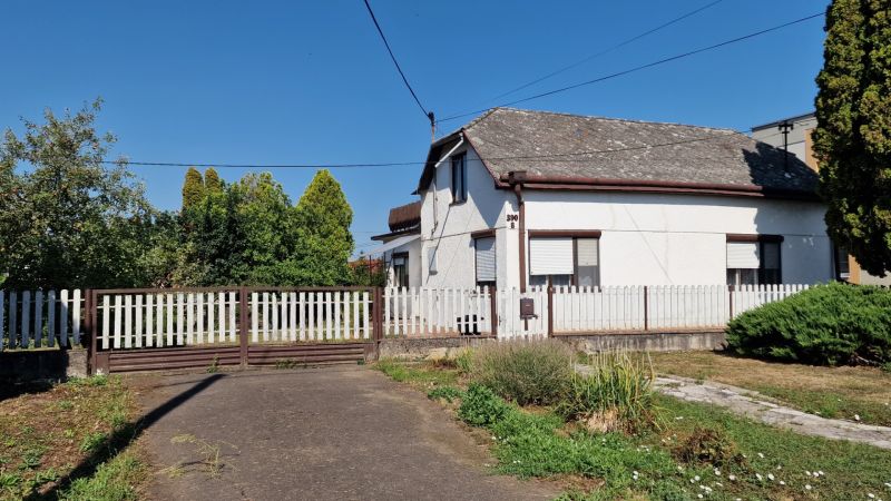 A family house on 29th August Street in Trebišov with a white wooden fence and a garden.