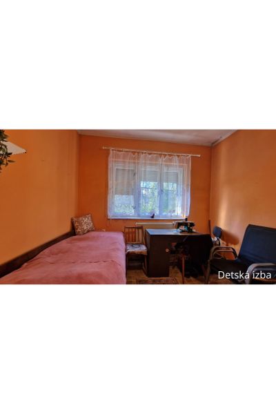Children's room with a desk, bed, and window, floor with wooden decor, family house.