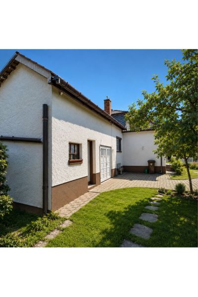 A family house on 29th August Street in Trebišov with a landscaped garden and paving.