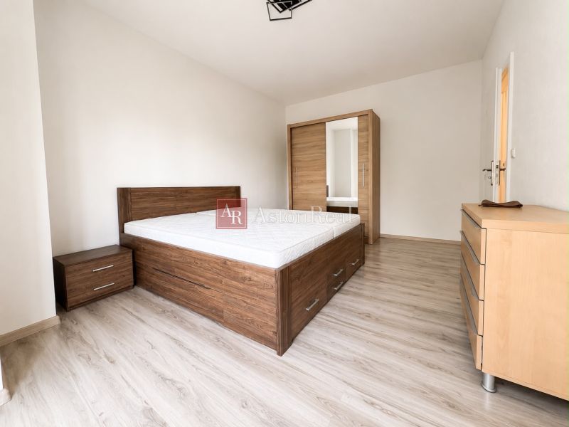 Bedroom in a 3-room apartment with wood-patterned flooring and furniture.
