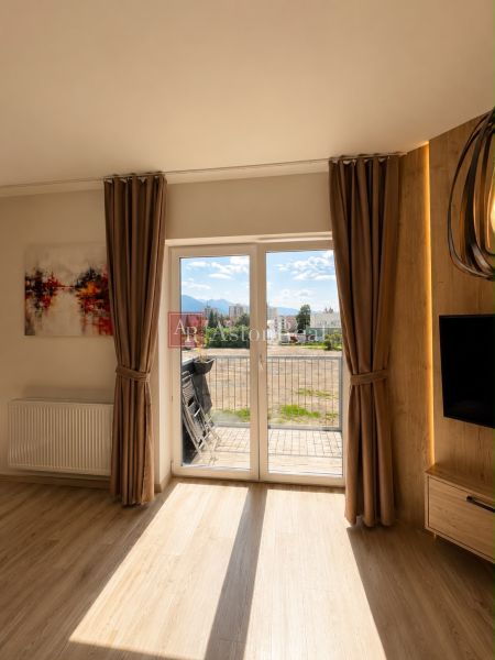 A room in a 3-room apartment with a balcony and a floor with a wooden decor.