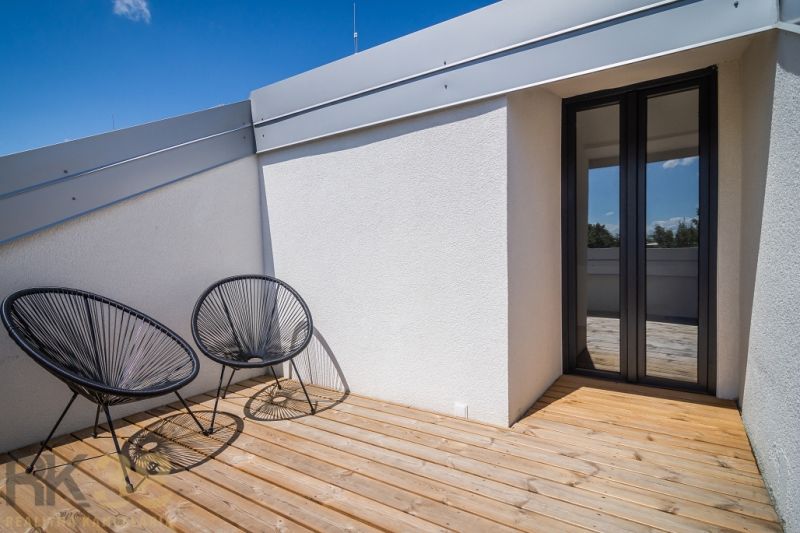 Terrace of the Recreational Apartment in Zemplínska Šírava with comfortable chairs and wooden decor.