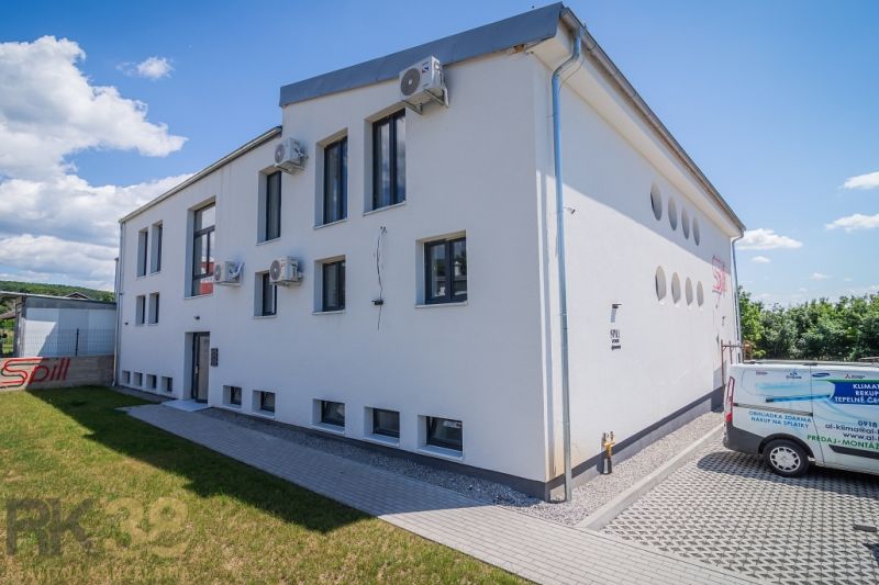 White modern building with a parking lot and air conditioning units in Zemplínska Šírava.