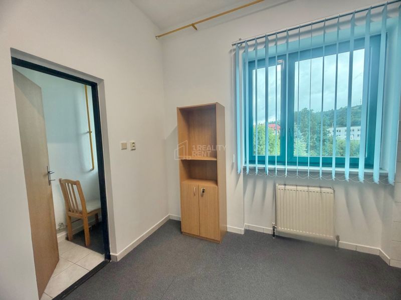 Office with a window, blinds, cabinet, and chair, floor with wooden decor.