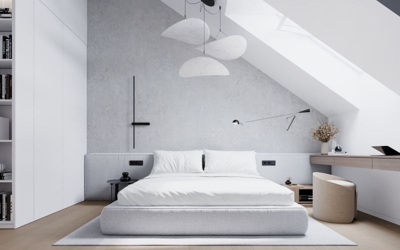 Elegant attic bedroom with a comfortable bed, writing desk, and wooden decor flooring.