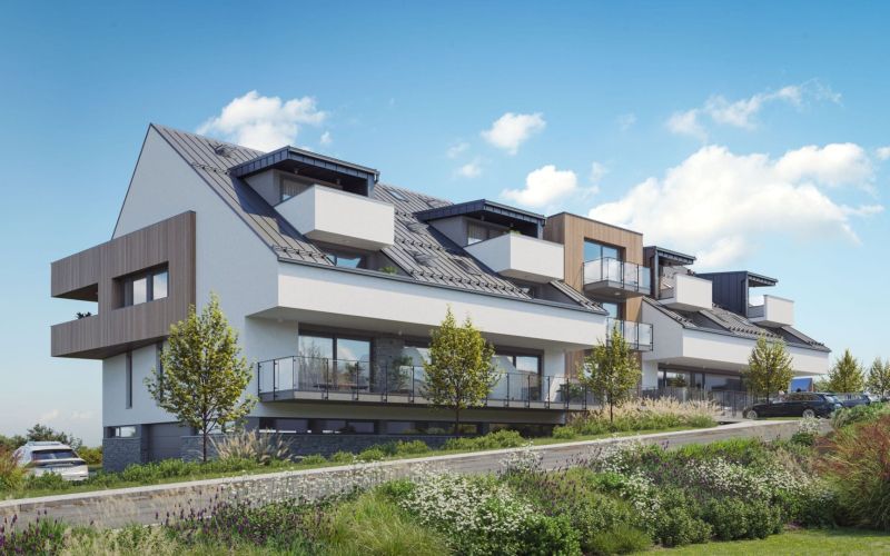 Apartment complex in Mlynica with green gardens and glass balconies.
