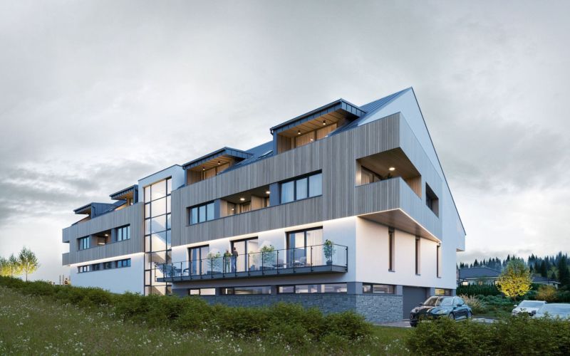 Modern architecture of the apartment complex in Mlynica with balconies and green surroundings.