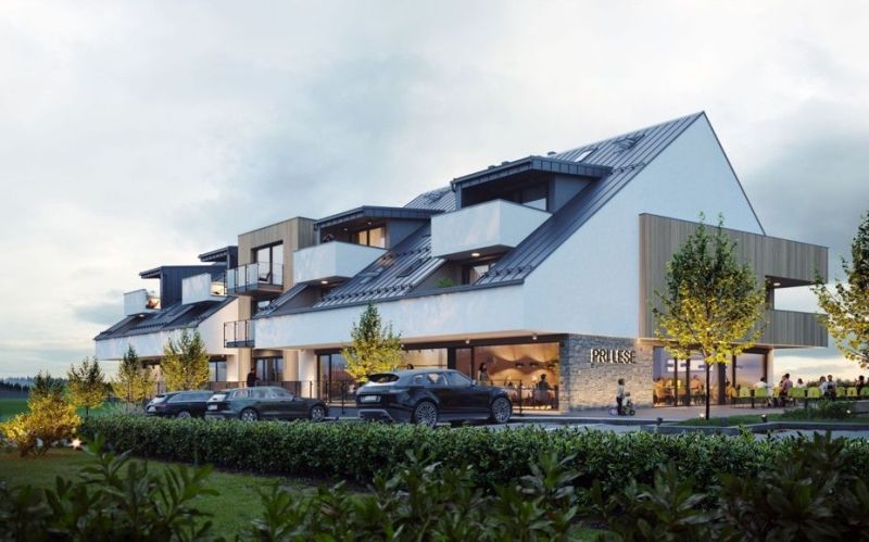 A building with modern architecture and cars in Mlynica.