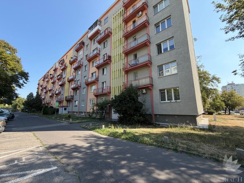 Apartment building on Sklenárova Street in Bratislava - Ružinov with greenery and parking.