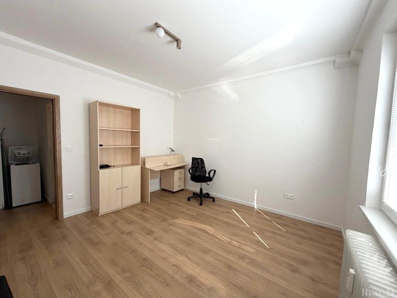 A room in a 3-room apartment with furniture and a wooden decor floor.