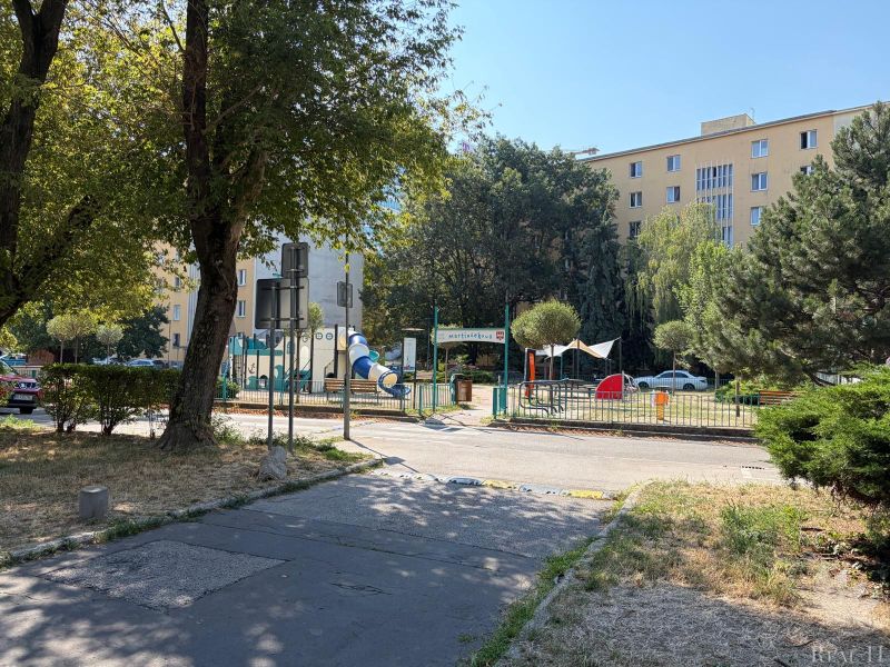 A children's playground surrounded by greenery on Sklenárova Street in Bratislava - Ružinov.