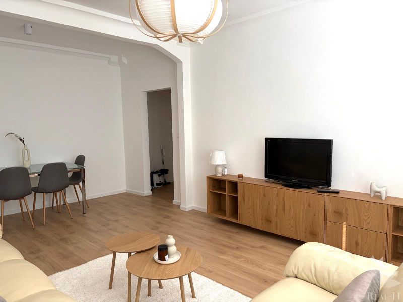 Living room in a 3-room apartment with a wooden decor floor and furniture.