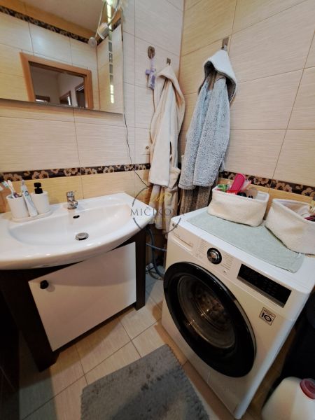 Bathroom with a sink and a washing machine in a 3-room apartment.