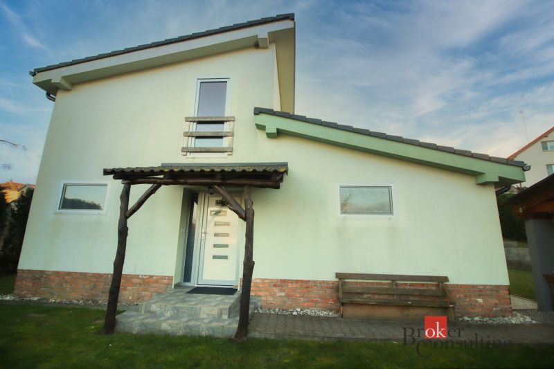 A family house in Suchá nad Parnou with an external staircase and a wooden veranda.
