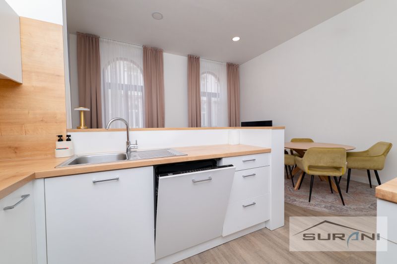 A kitchen with wooden decor and a dining table in a 2-room apartment.