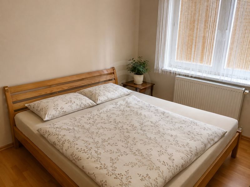 A bedroom with wooden furniture and a wooden decor floor in a family house.