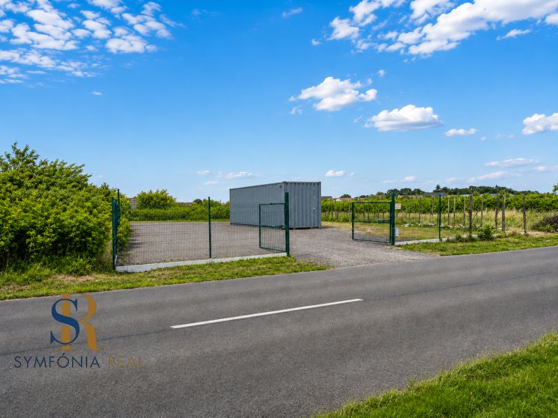 A plot for residential use in Modra on street 504 with fencing and a container.