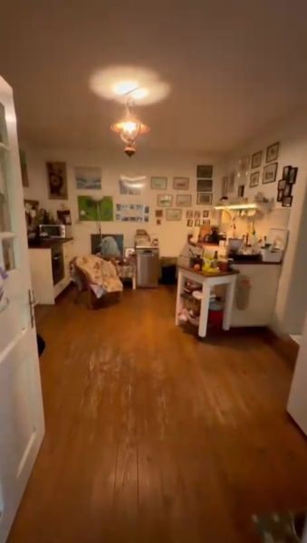 Interior of a family house with a wooden decor floor, decorative elements on the walls.