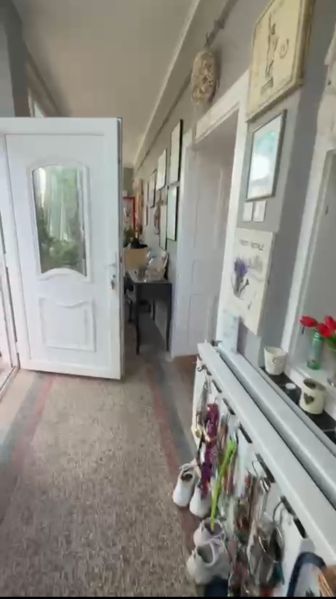 A hallway in a family house with white doors and decorations on the walls.