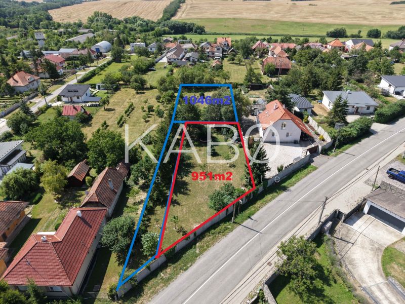 Aerial view of residential plots in Čaradice with houses and greenery.