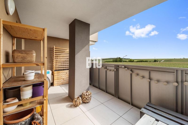 A balcony in a 4-room apartment in Nitra with a view of the surrounding countryside.