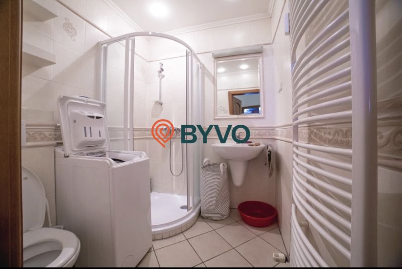 The bathroom in the 3-room apartment includes a shower, a sink, and a washing machine.