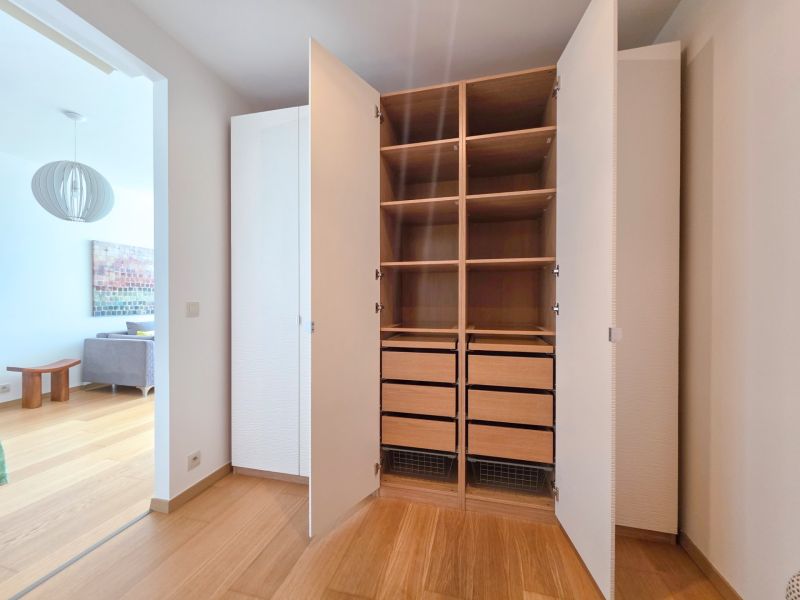 1-bedroom apartment with a spacious walk-in closet and wood-patterned flooring.