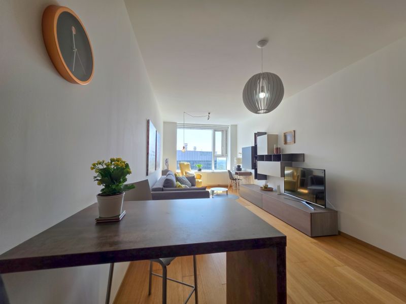 A stylish living area with wood-patterned flooring in a studio apartment.