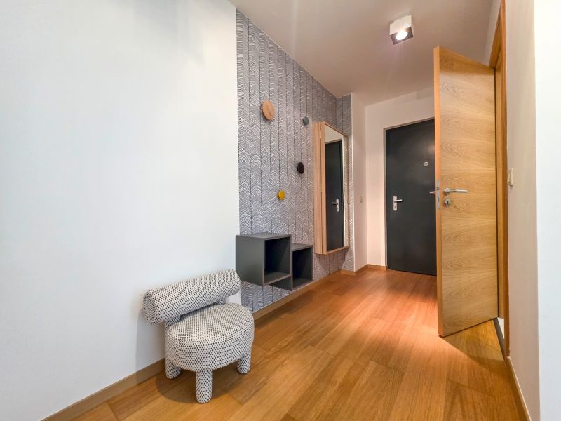 Interior of a 1-room apartment with a decorative wall and floor with a wood decor.