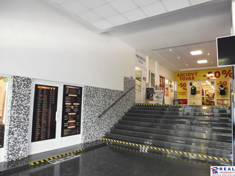 In the offices, there is a staircase with tiled flooring and mosaic decoration on the wall.